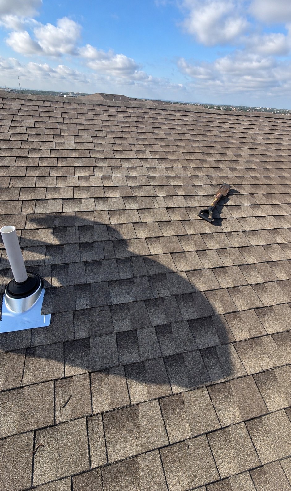 Pipe boot flashing on multifamily roof after repair