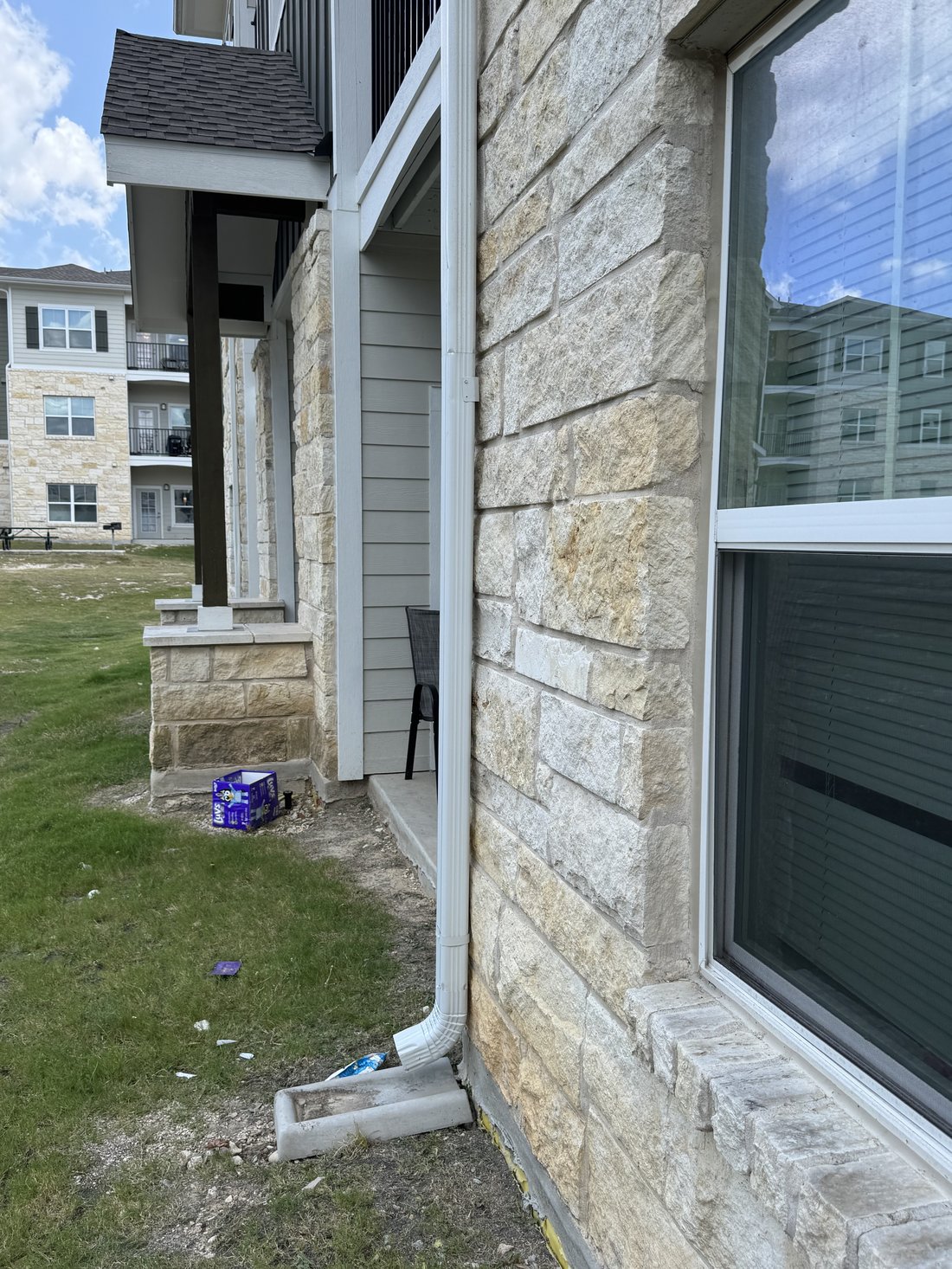 New downspout section installed and secured to the wall