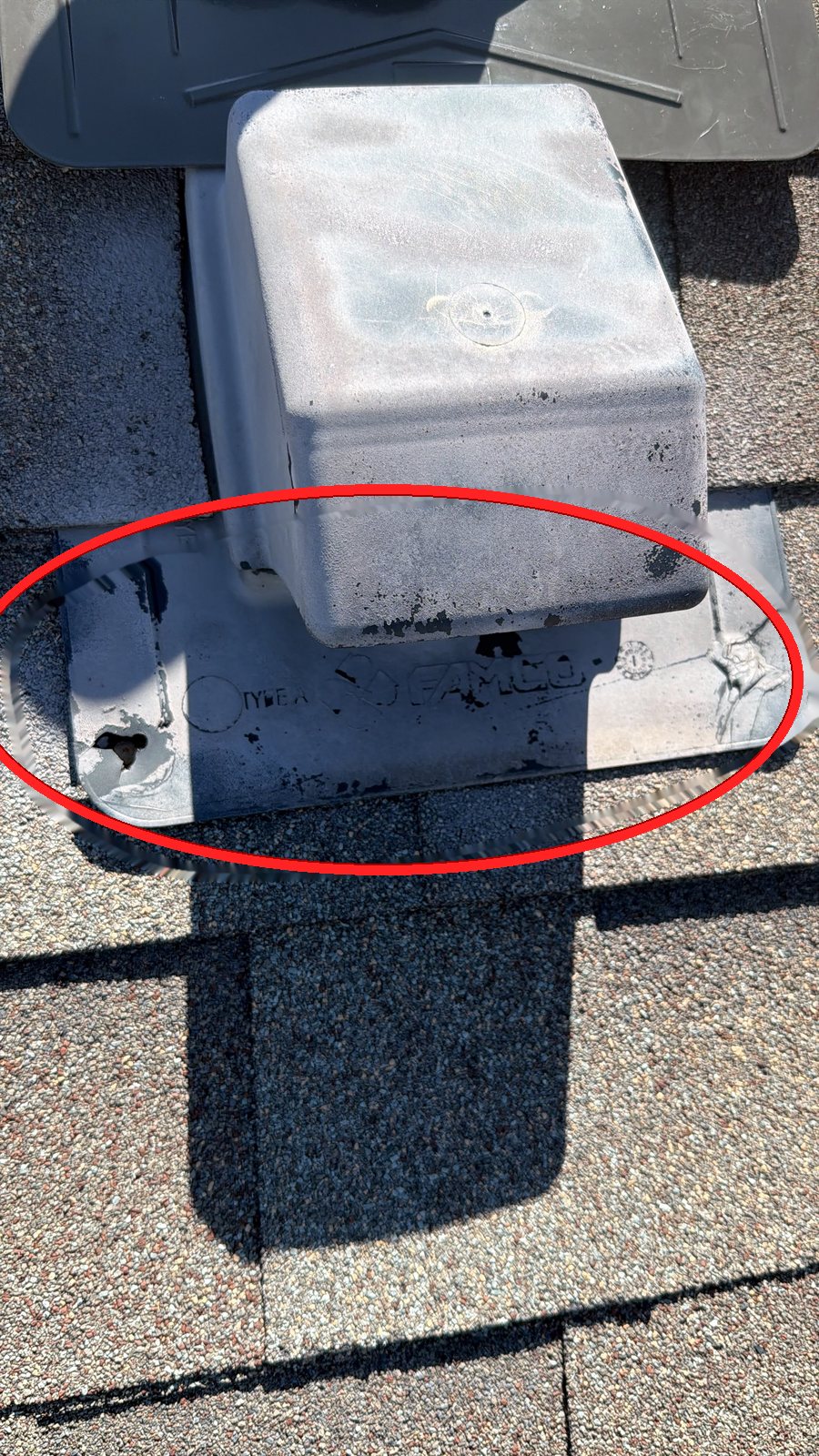 Weathered FAMCO plastic roof vent with punctured flange and failed sealant highlighted