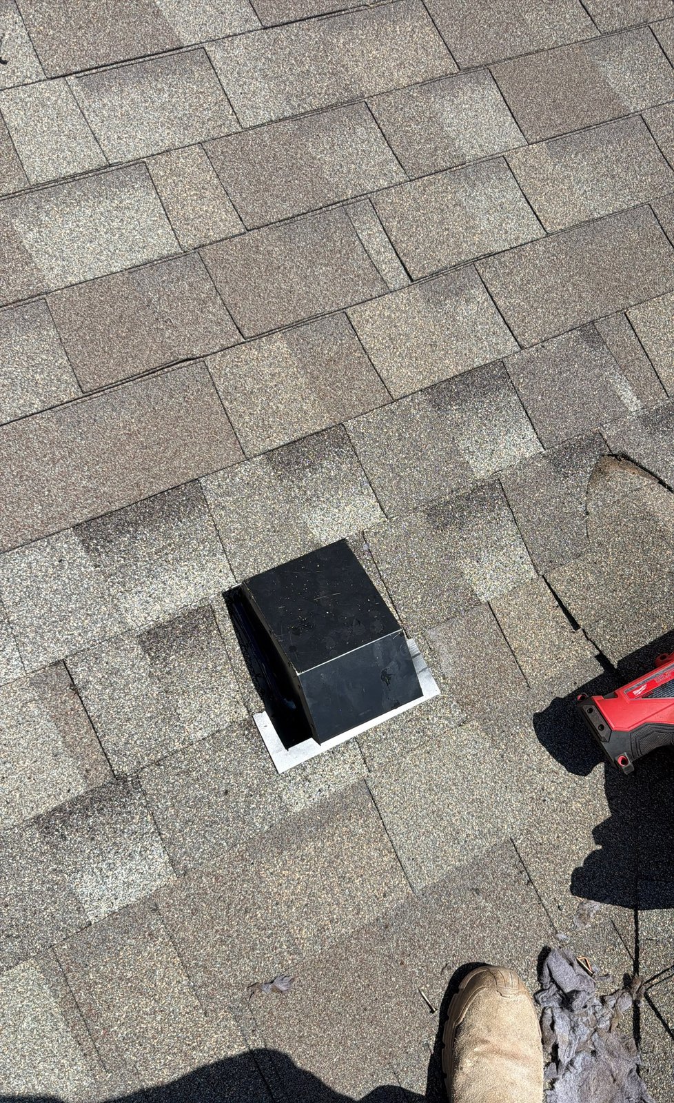 Finished black metal gooseneck vent set into architectural shingles