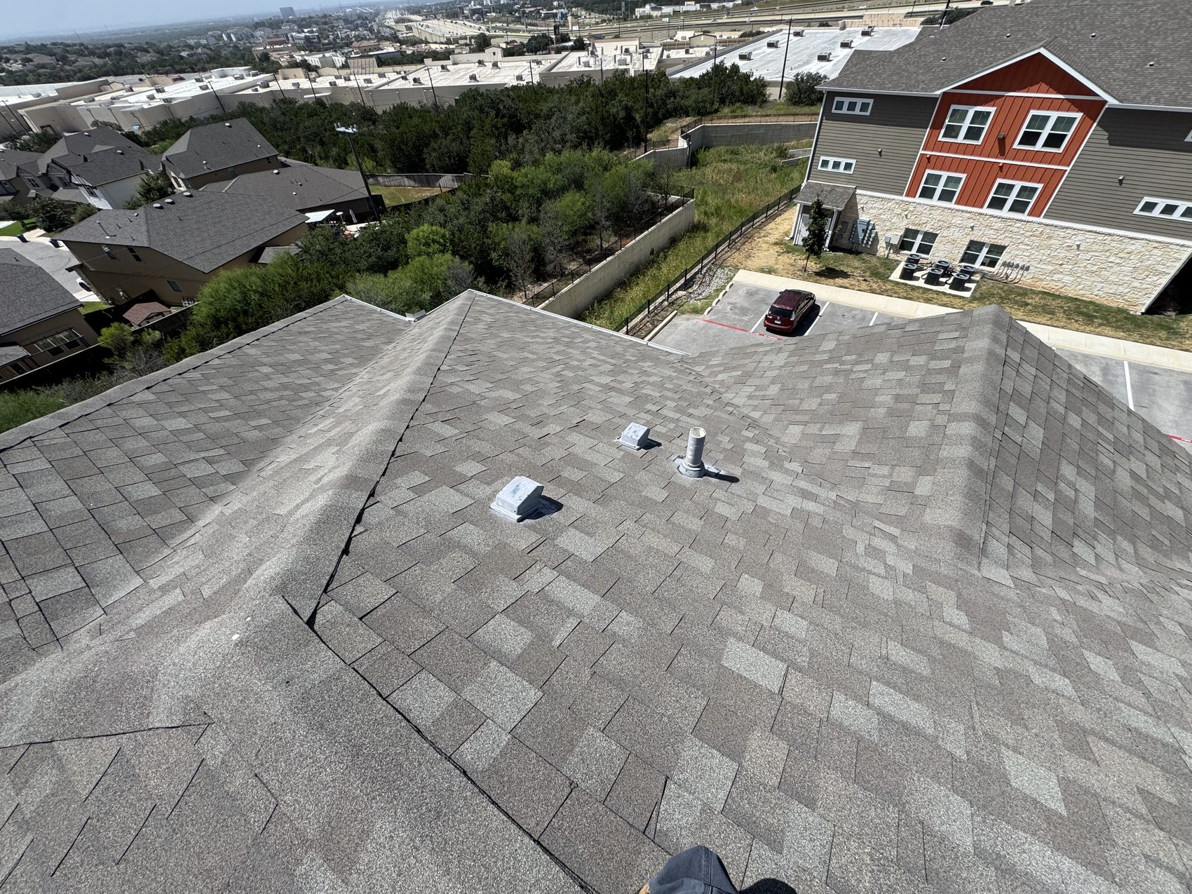 Static vents and pipe stack on a multifamily roof slope